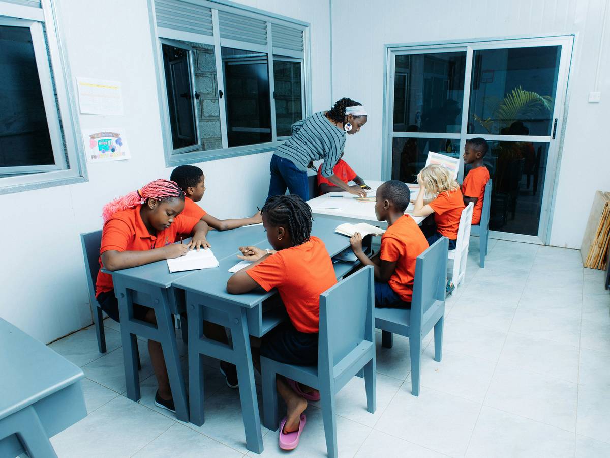 school management games simulation showing a detailed overhead view of a virtual campus with classrooms, staff icons, and budget charts