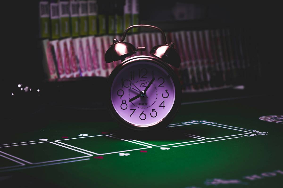 Player organizing daily video game routine with planner and gameplay screen showing time management UI